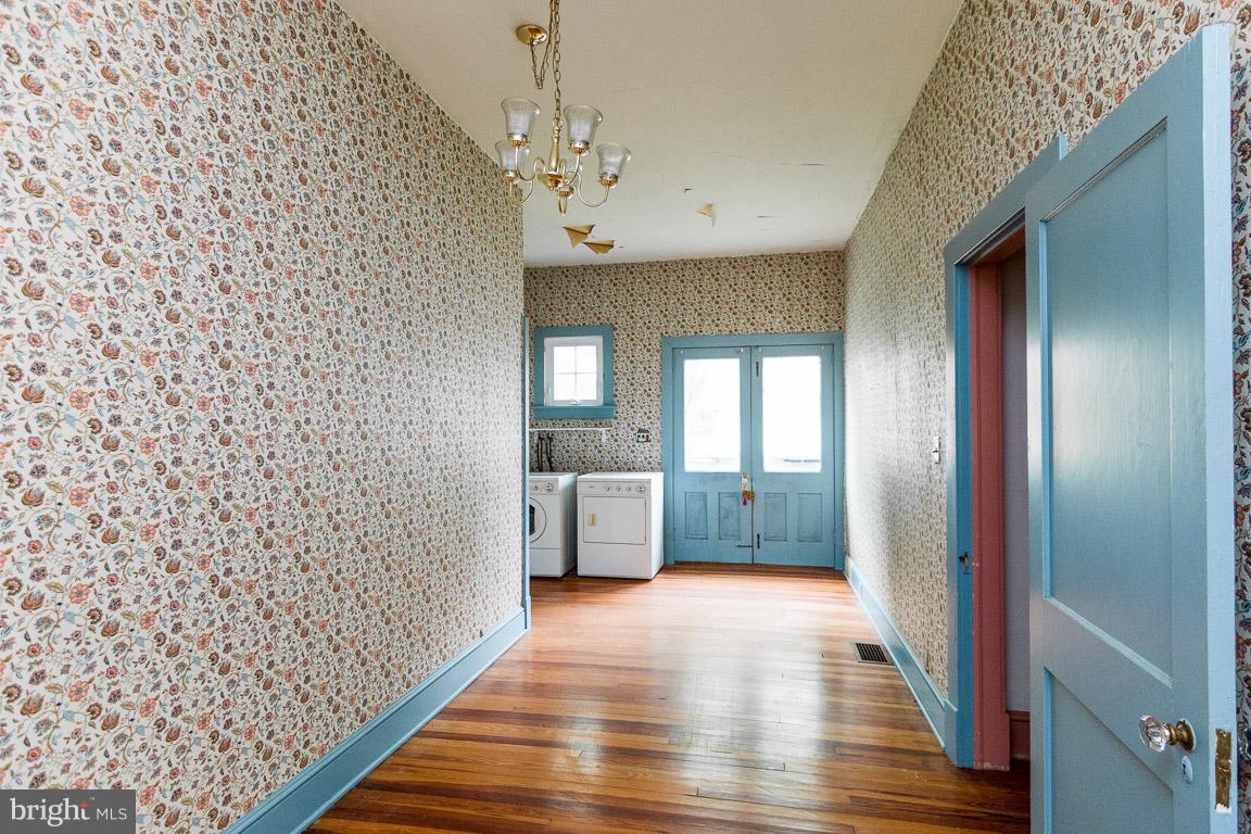 5760 Middleburg Road Keymar, MD 21757 - Photo 12 of 25 a view of a hallway with wooden floor and staircase