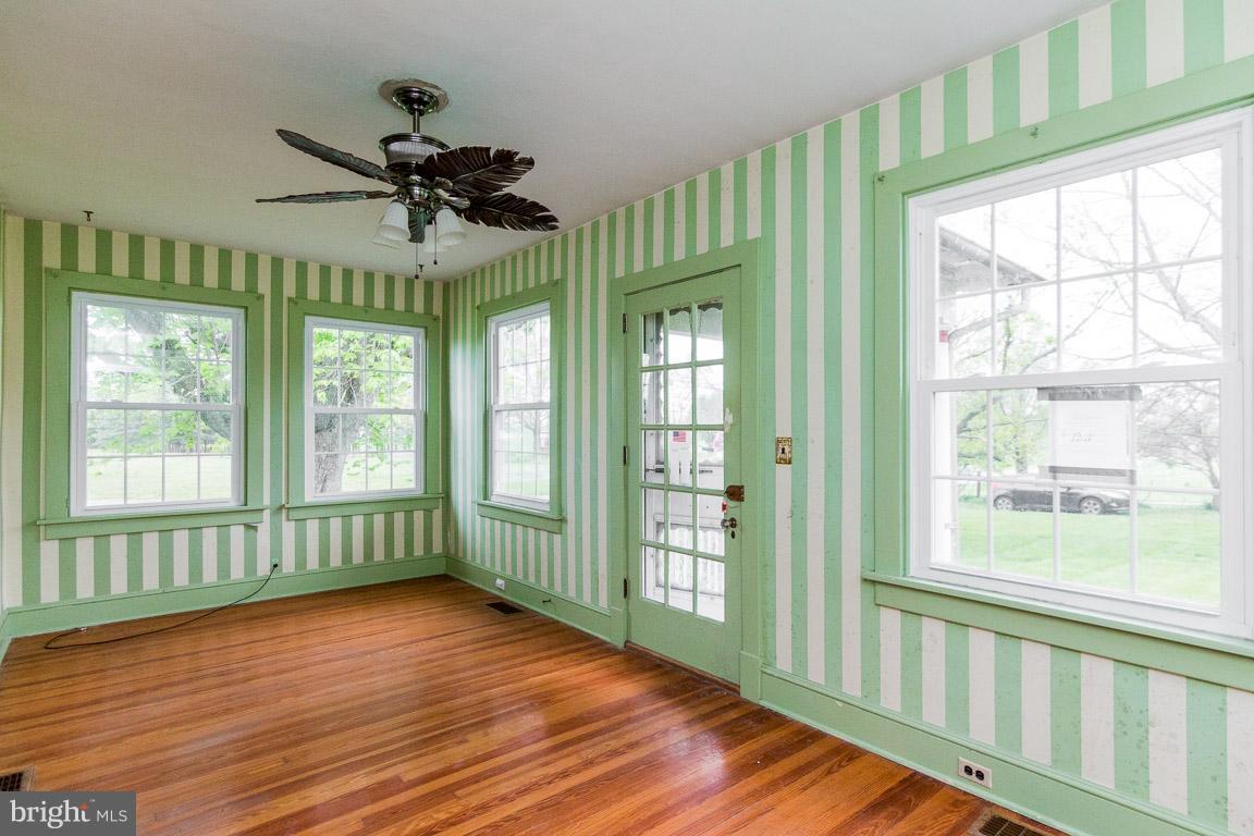 5760 Middleburg Road Keymar, MD 21757 - Photo 20 of 25 a view of an empty room with wooden floor and a window
