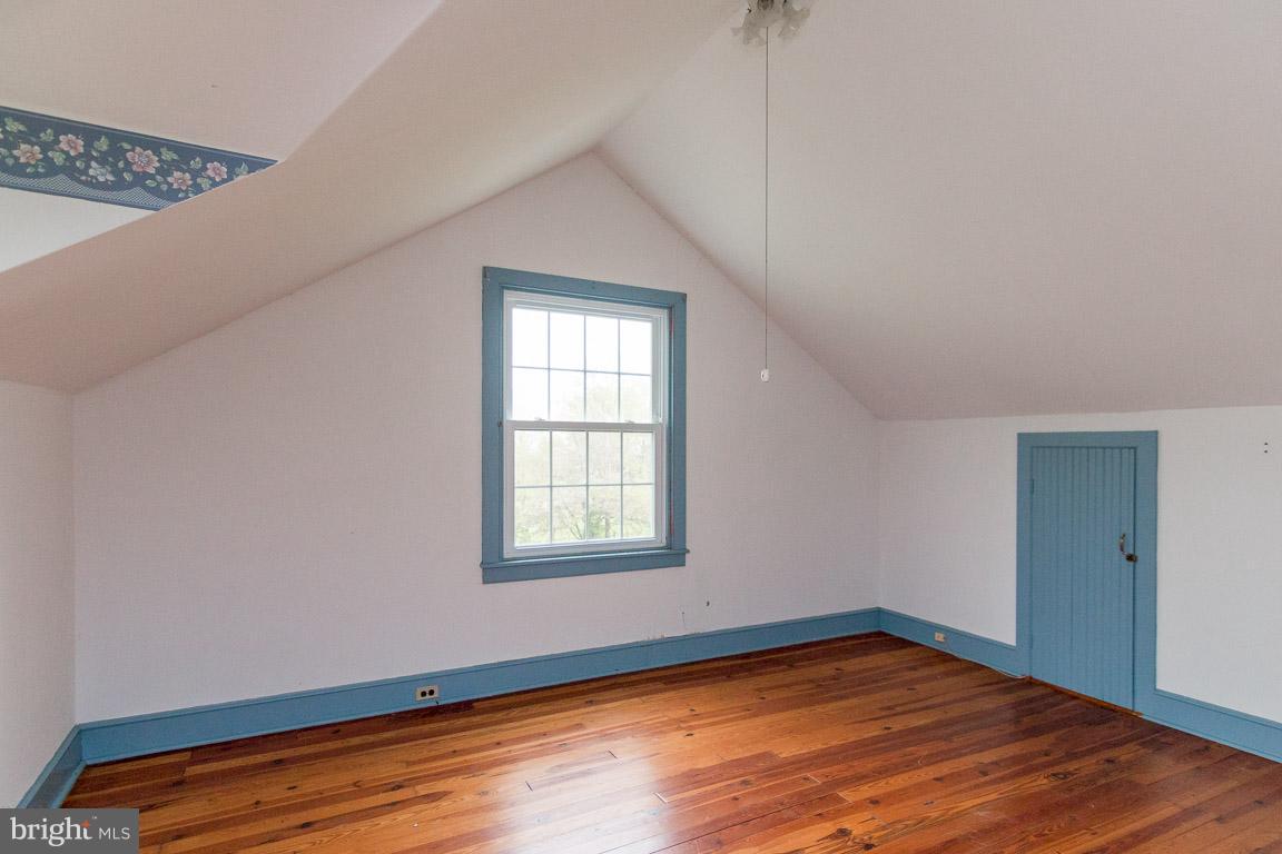 5760 Middleburg Road Keymar, MD 21757 - Photo 21 of 25 an empty room with wooden floor and windows