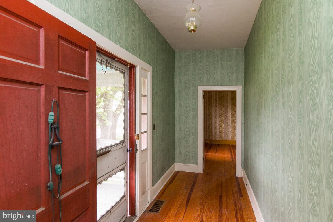 5760 Middleburg Road Keymar, MD 21757 - Photo 6 of 25 a view of a hallway with wooden floor and a window