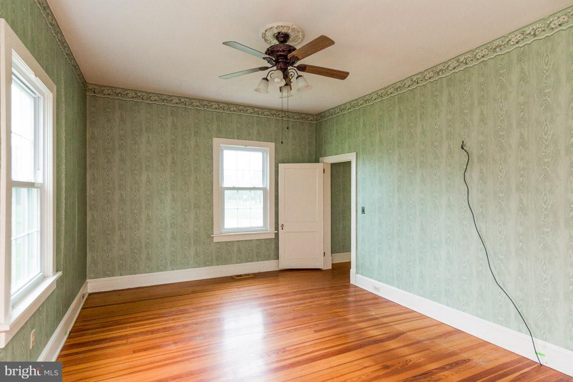 5760 Middleburg Road Keymar, MD 21757 - Photo 8 of 25 a view of empty room with wooden floor and fan