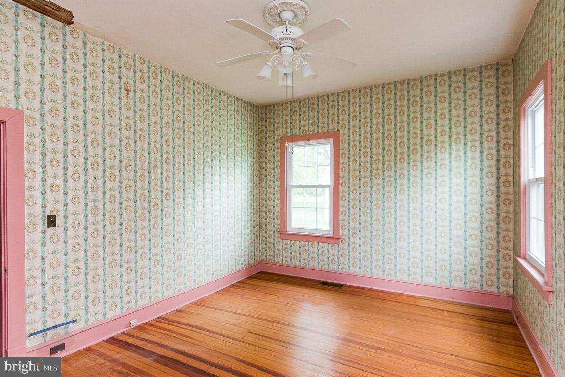 5760 Middleburg Road Keymar, MD 21757 - Photo 9 of 25 a view of an empty room with a window and wooden floor