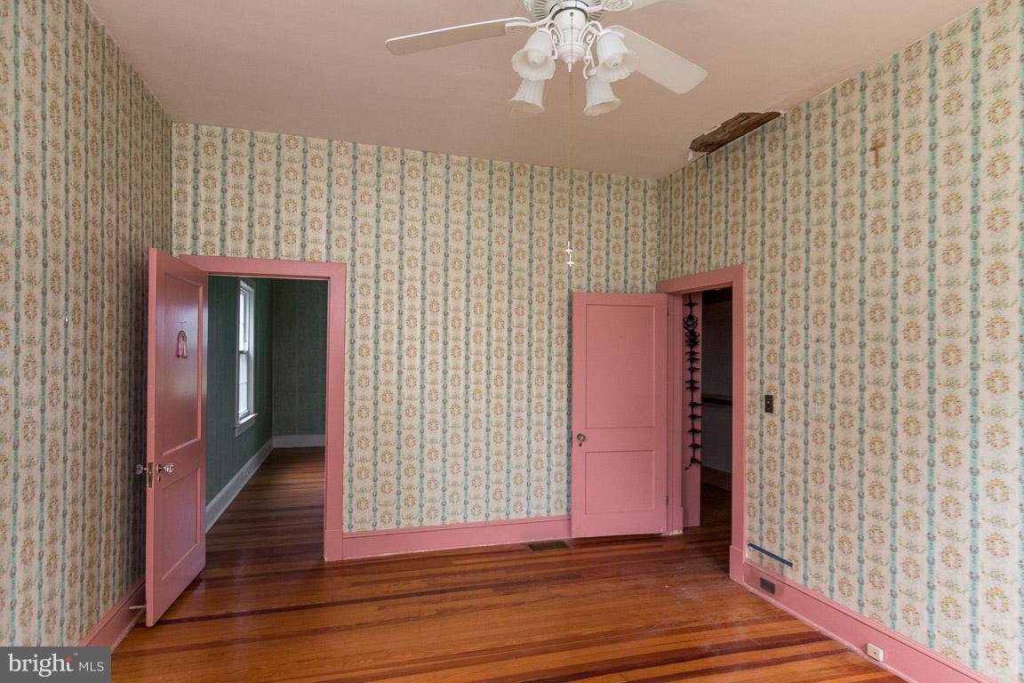 5760 Middleburg Road Keymar, MD 21757 - Photo 10 of 25 a view of a hallway with wooden floor and staircase
