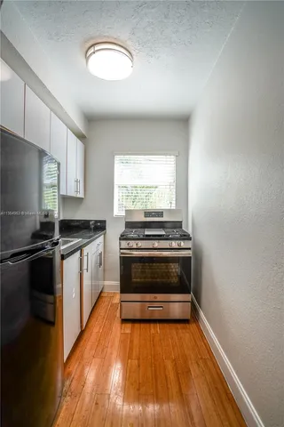 a kitchen with a stove and a microwave