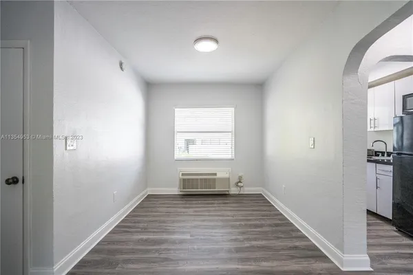 a view of room with window and wooden floor