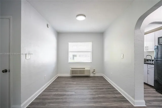 a view of room with window and wooden floor