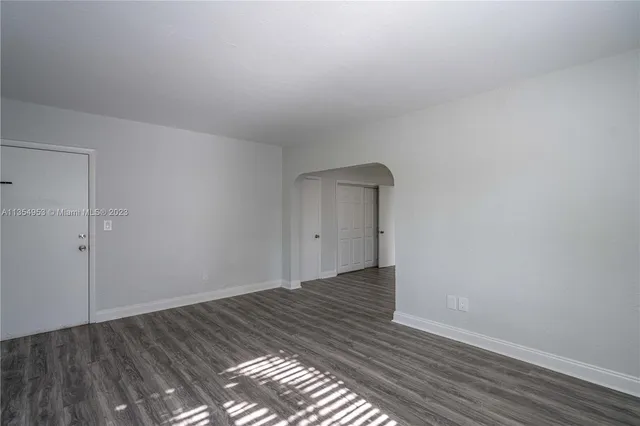 a view of an empty room and wooden floor