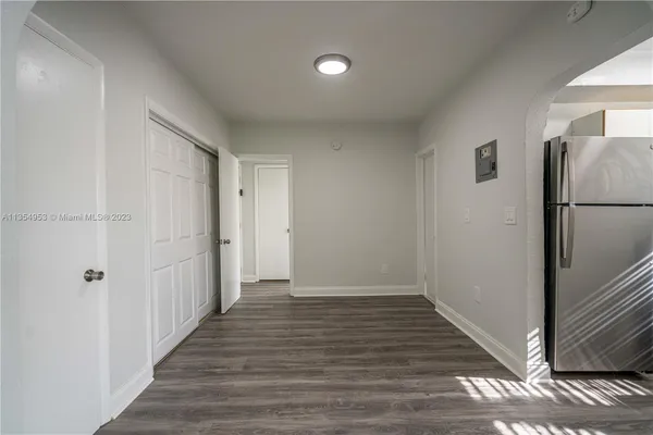 a view of a hallway with wooden floor