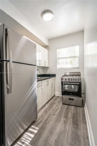 a kitchen with a refrigerator and a stove