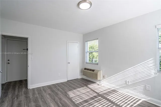 a view of wooden floor and windows in a room