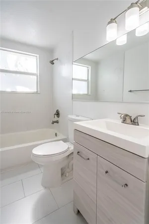 a bathroom with a sink a toilet and bathtub