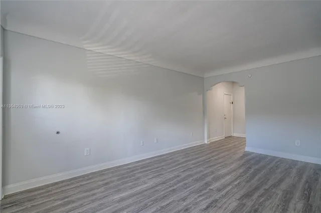 a view of an empty room and wooden floor