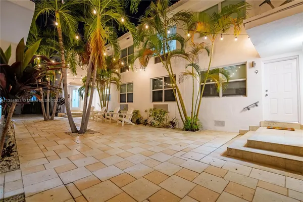 a view of a chairs and table in front of a house