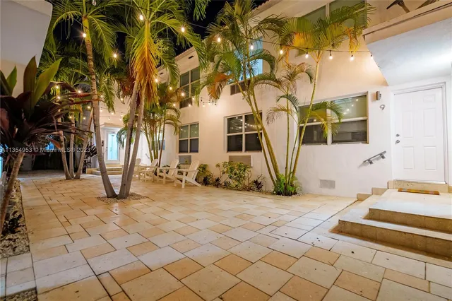 a view of a chairs and table in front of a house