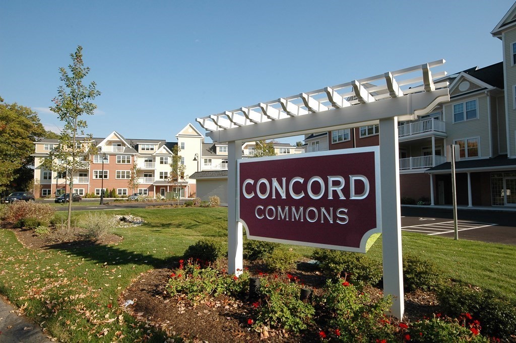 95 Conant Street, Unit 304 Concord, MA 01742 - Photo 1 of 23 a sign that is sitting in front of flowers
