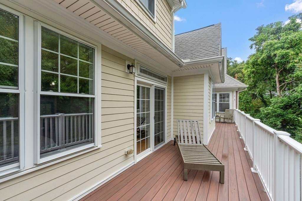 95 Conant Street, Unit 304 Concord, MA 01742 - Photo 12 of 23 a view of a deck with wooden floor and fence