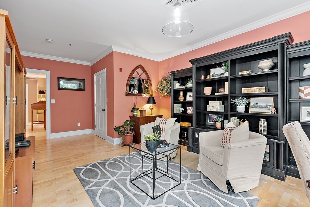 95 Conant Street, Unit 304 Concord, MA 01742 - Photo 3 of 23 a living room with furniture a bookshelf and a large window