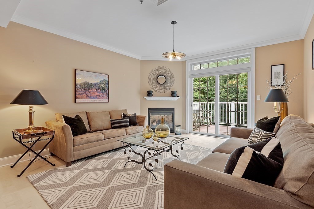 95 Conant Street, Unit 304 Concord, MA 01742 - Photo 6 of 23 a living room with furniture a large window and a chandelier