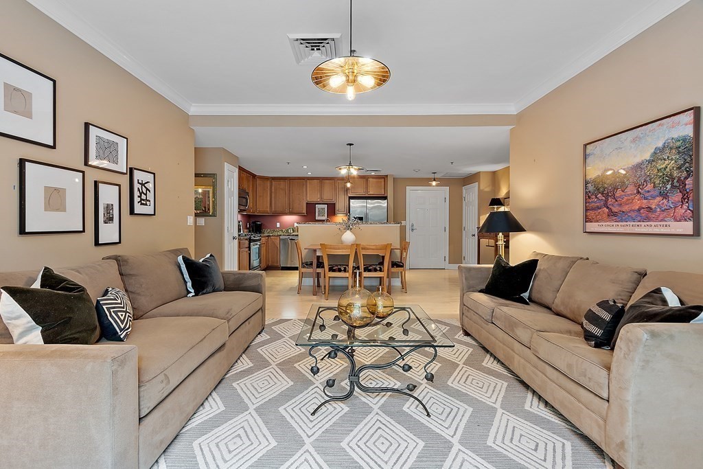 95 Conant Street, Unit 304 Concord, MA 01742 - Photo 8 of 23 a living room with furniture chandelier and a chandelier