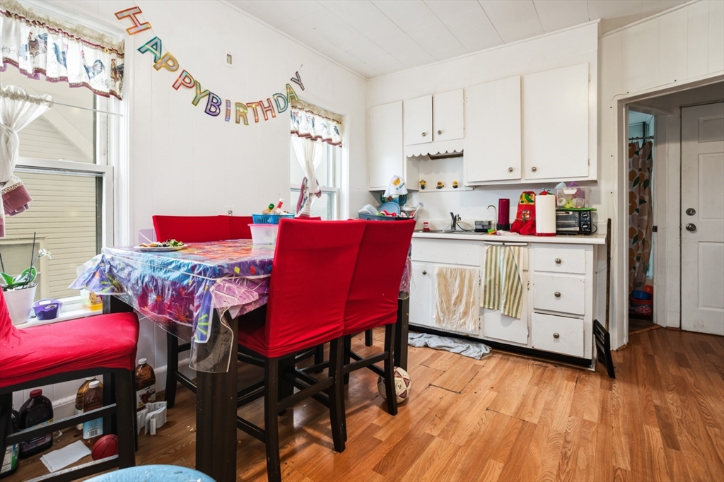 17 Ashton Street Everett, MA 02149 - Photo 14 of 42 a view of a dining room with furniture and wooden floor