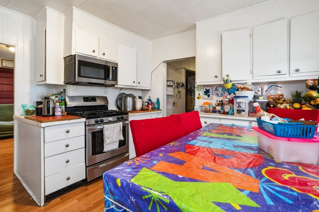 17 Ashton Street Everett, MA 02149 - Photo 15 of 42 a bedroom with a bed and a tv in it