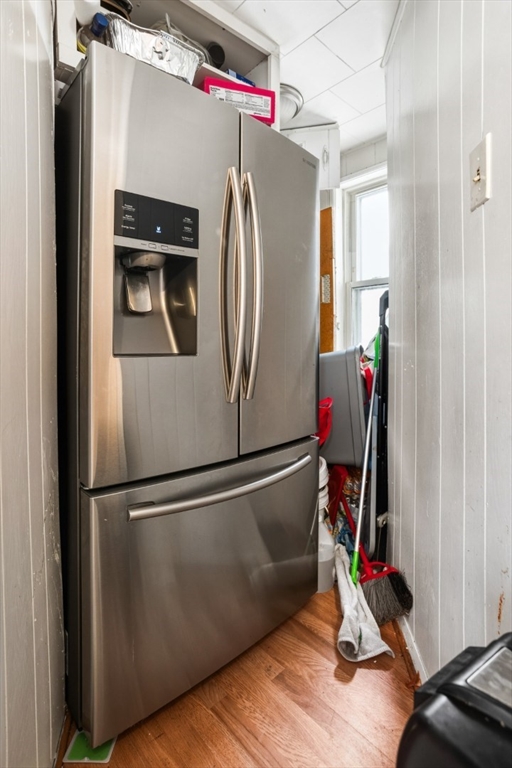17 Ashton Street Everett, MA 02149 - Photo 16 of 42 a view of a refrigerator with wooden floor