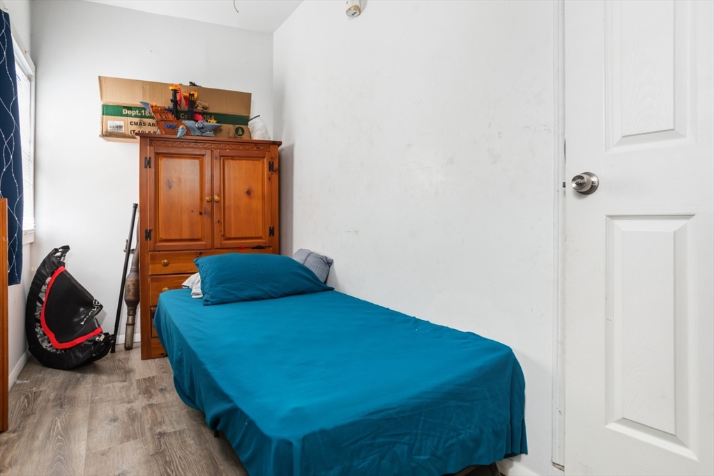 17 Ashton Street Everett, MA 02149 - Photo 17 of 42 a bedroom with a bed and cabinets