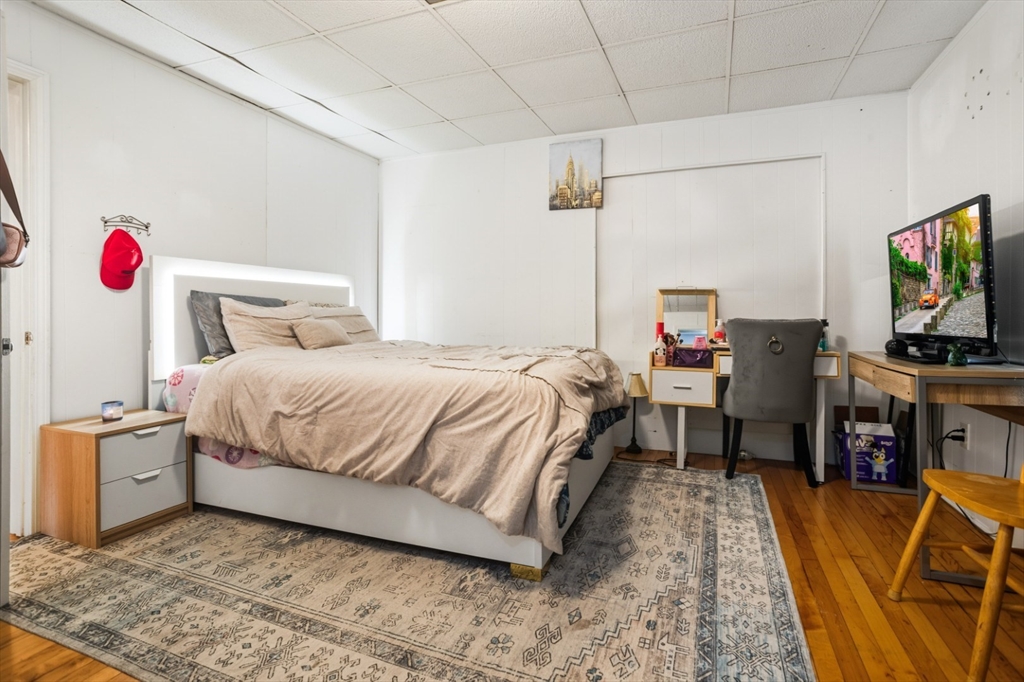 17 Ashton Street Everett, MA 02149 - Photo 19 of 42 a bedroom with a bed and a flat screen tv