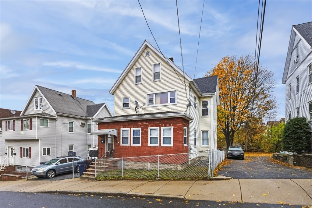 17 Ashton Street Everett, MA 02149 - Photo 2 of 42 a view of a big house with a yard and plants
