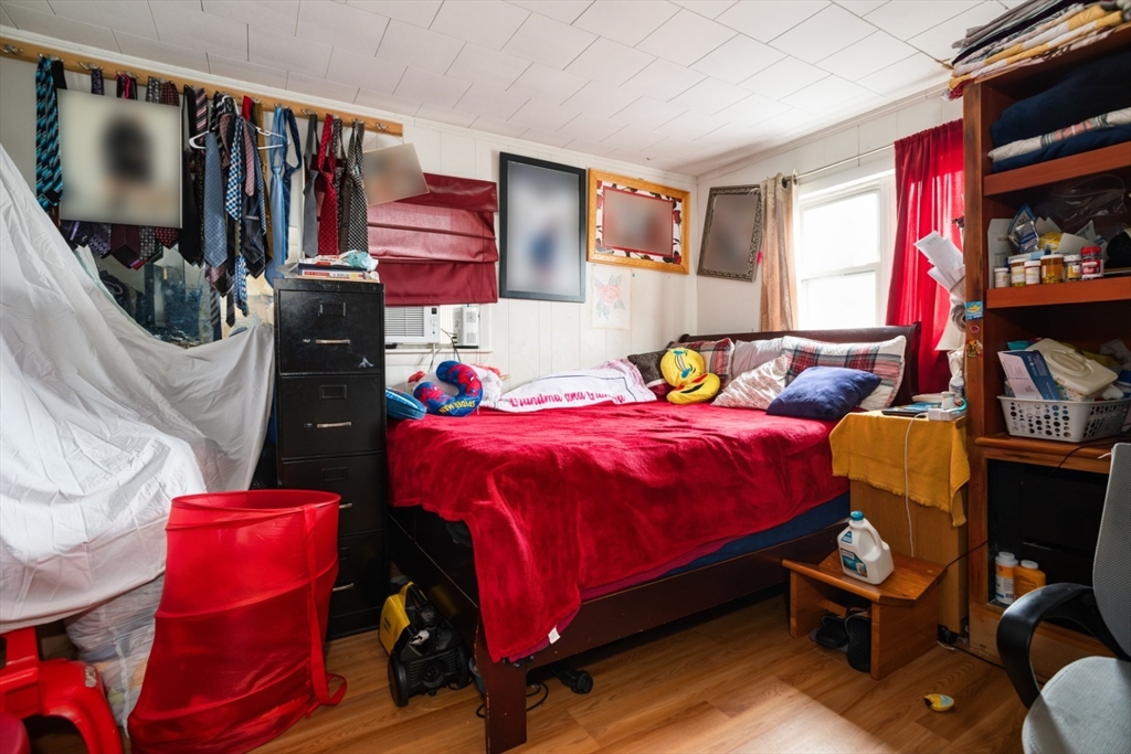 17 Ashton Street Everett, MA 02149 - Photo 22 of 42 a bedroom with a bed a books bucket with a desk and chair