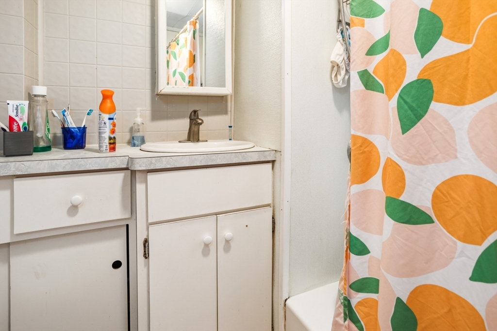 17 Ashton Street Everett, MA 02149 - Photo 31 of 42 a bathroom with a sink mirror and vanity