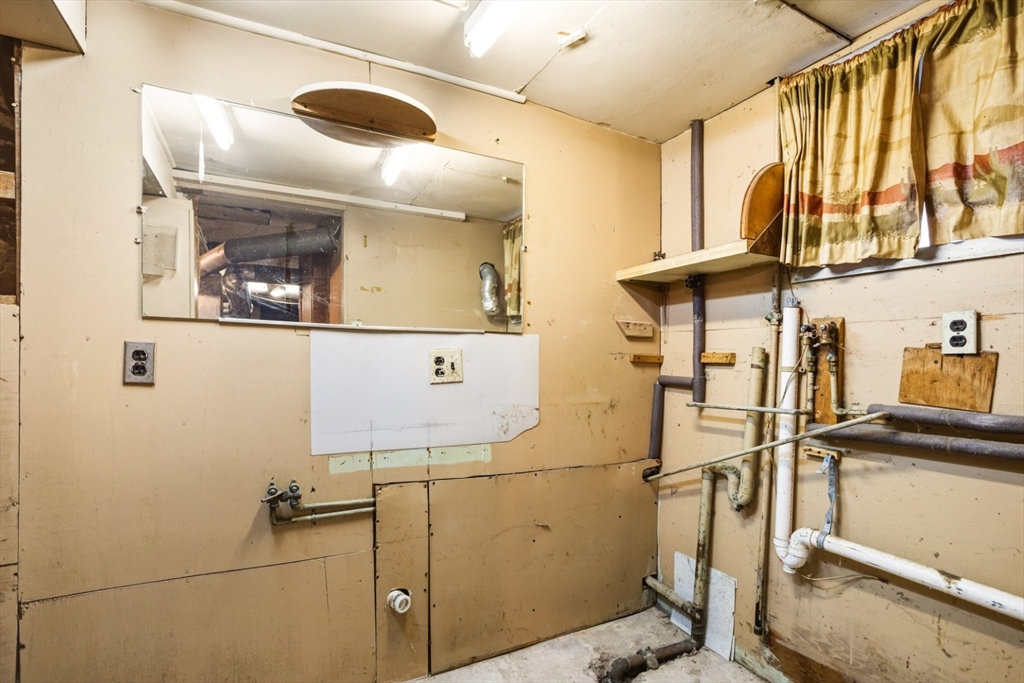 17 Ashton Street Everett, MA 02149 - Photo 37 of 42 a bathroom with a sink and mirror