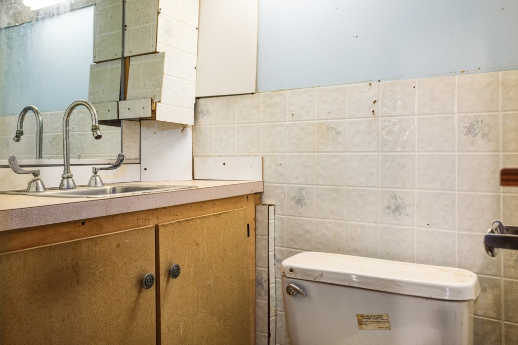 17 Ashton Street Everett, MA 02149 - Photo 38 of 42 a bathroom with a sink a toilet and mirror