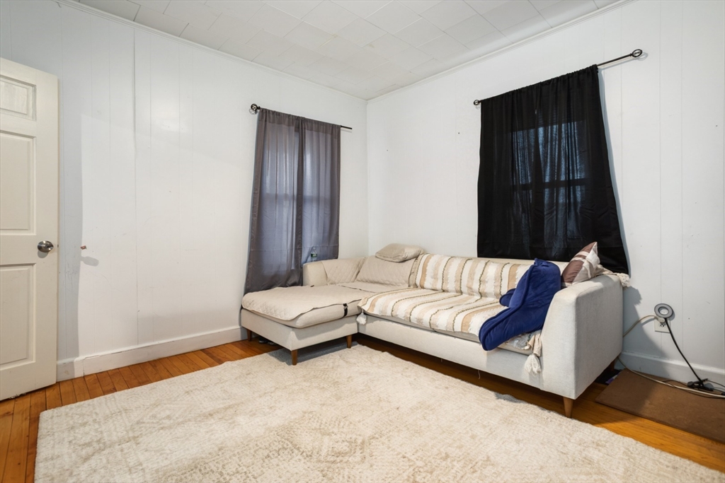 17 Ashton Street Everett, MA 02149 - Photo 5 of 42 a living room with furniture and a window