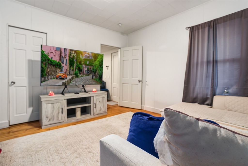 17 Ashton Street Everett, MA 02149 - Photo 6 of 42 a bed room with a bed and a television