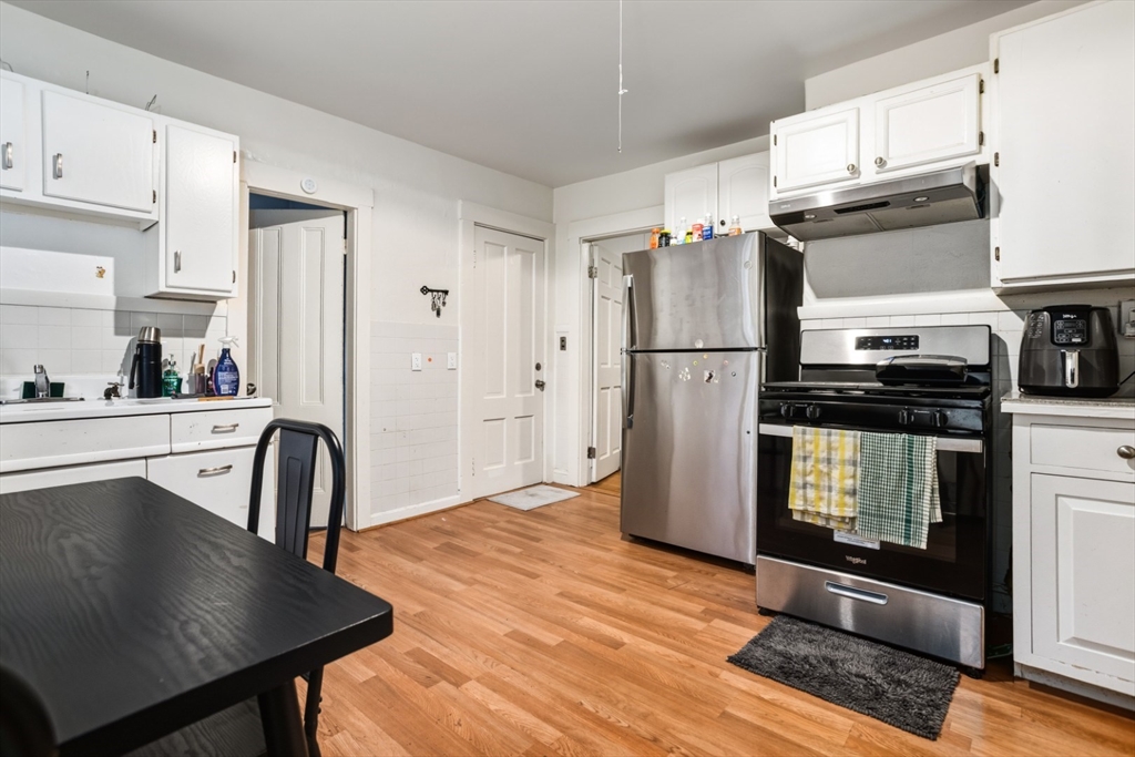 17 Ashton Street Everett, MA 02149 - Photo 7 of 42 a kitchen with granite countertop a refrigerator stove and sink