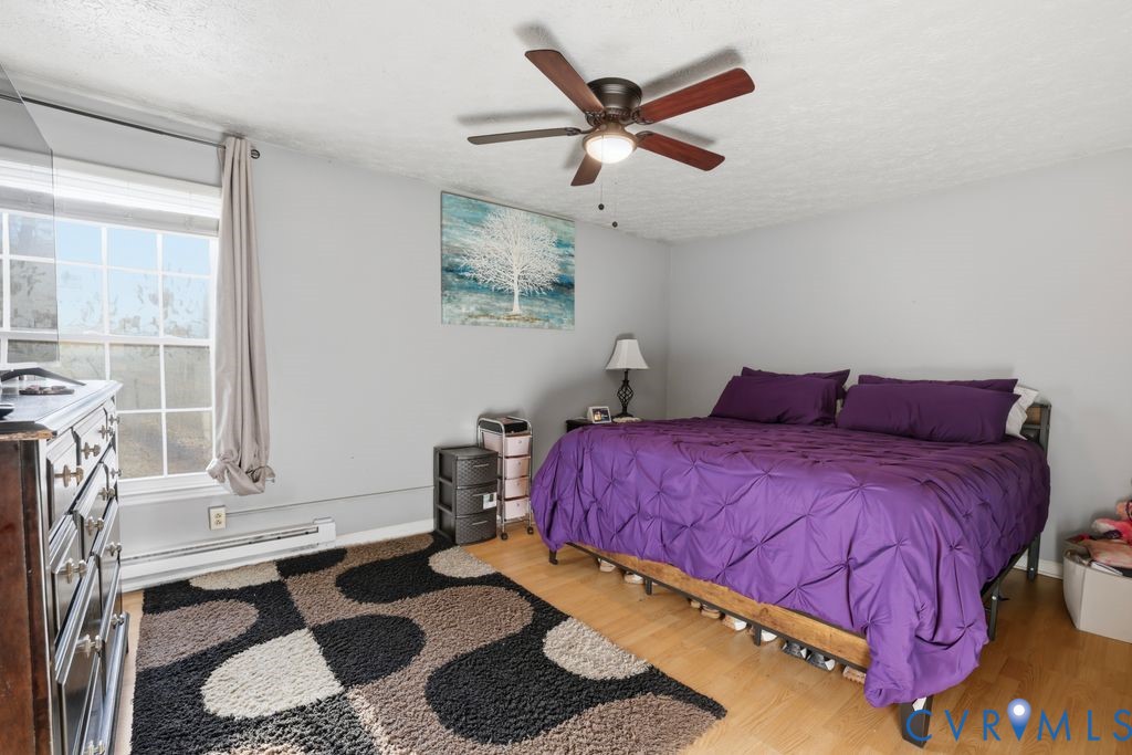 21104 Matoaca Road Petersburg, VA 23803 - Photo 13 of 22 a bedroom with a bed a chandelier and a window