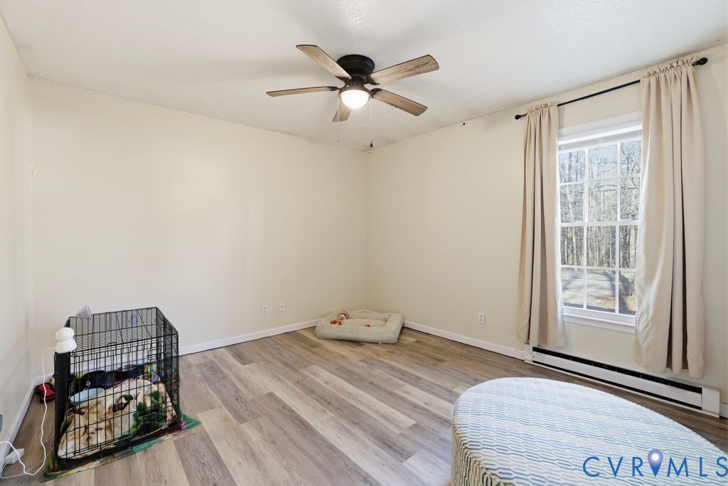 21104 Matoaca Road Petersburg, VA 23803 - Photo 18 of 22 a bedroom with a bed and wooden floor