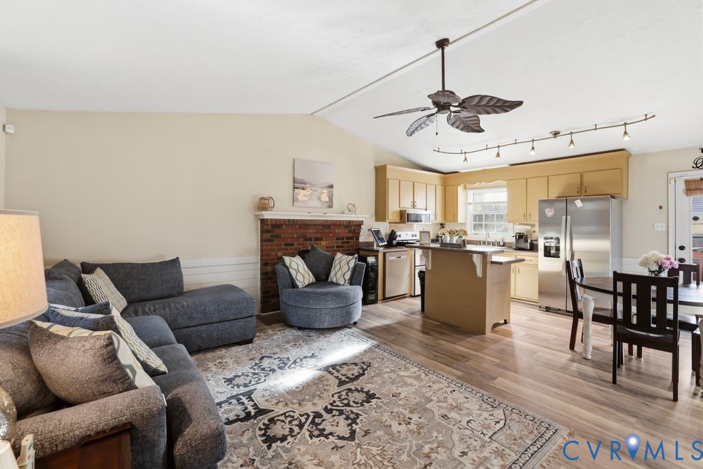 21104 Matoaca Road Petersburg, VA 23803 - Photo 8 of 22 a living room with furniture a kitchen view and a chandelier