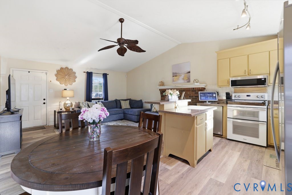 21104 Matoaca Road Petersburg, VA 23803 - Photo 10 of 22 a kitchen with a dining table chairs stainless steel appliances and cabinets