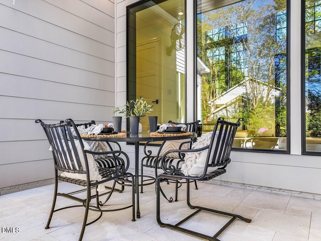 7013 Buckhead Drive Raleigh, NC 27615 - Photo 72 of 80 a view of a patio with table and chairs and potted plants