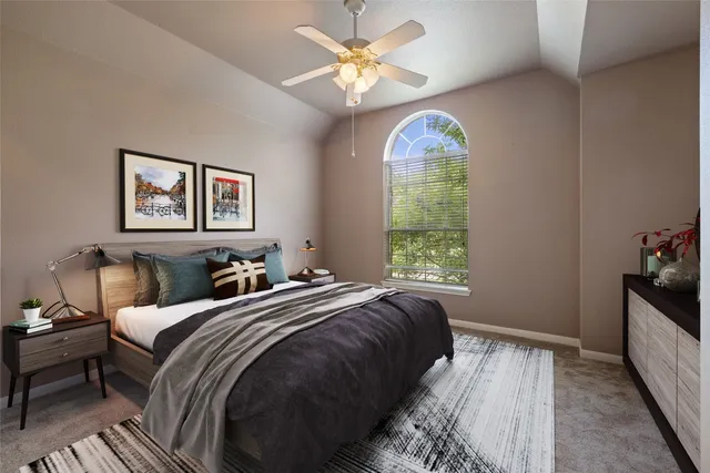 a bedroom with bed and a chandelier