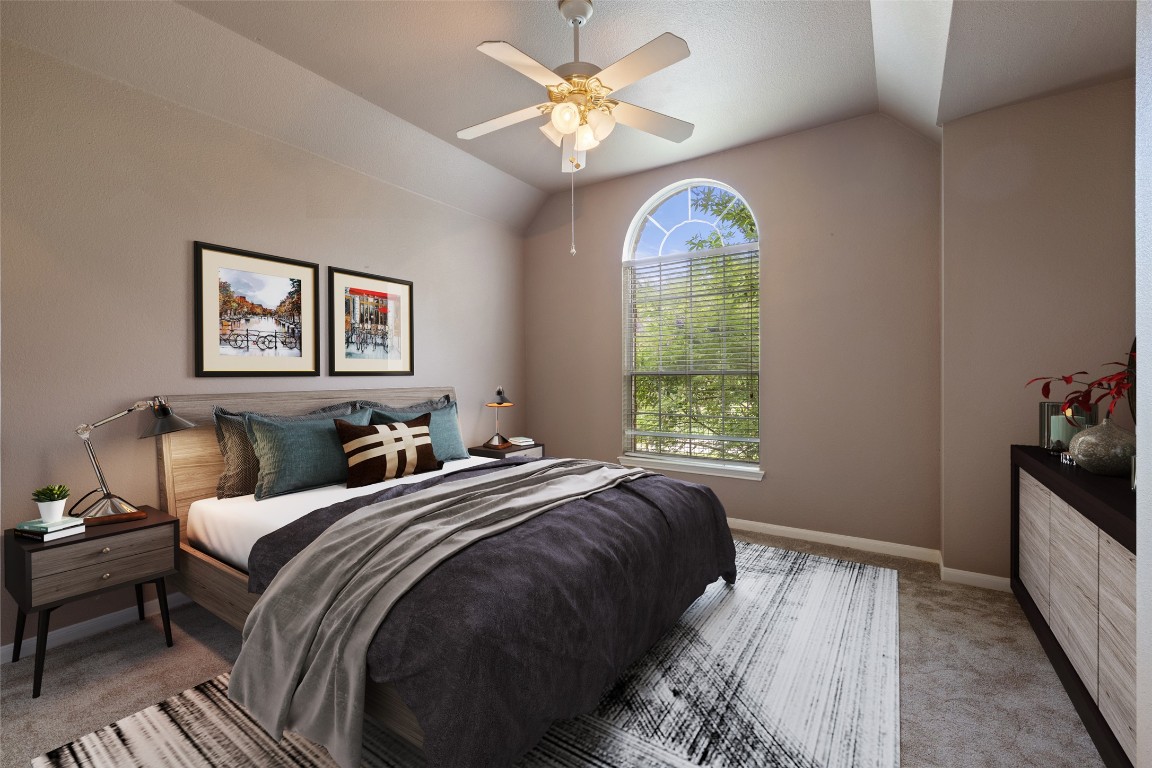 270 Rollin N Ranch Road Blanco, TX 78606 - Photo 19 of 27 a bedroom with bed and a chandelier