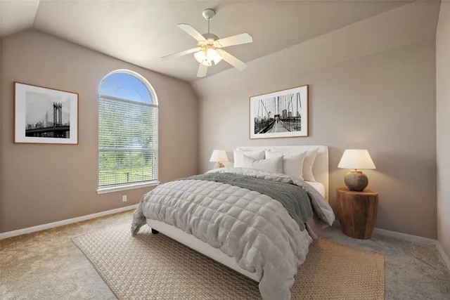 a bedroom with bed and window