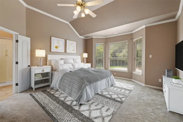 a bedroom with a bed and a chandelier