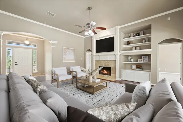 a living room with furniture a fireplace and a flat screen tv