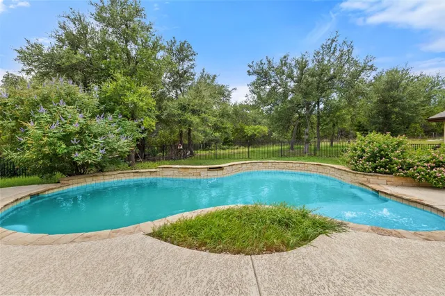 a view of a swimming pool and a yard