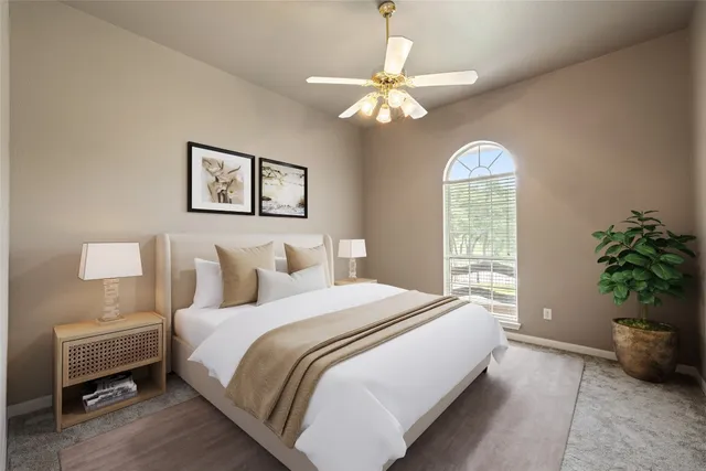 a bedroom with a bed and a chandelier