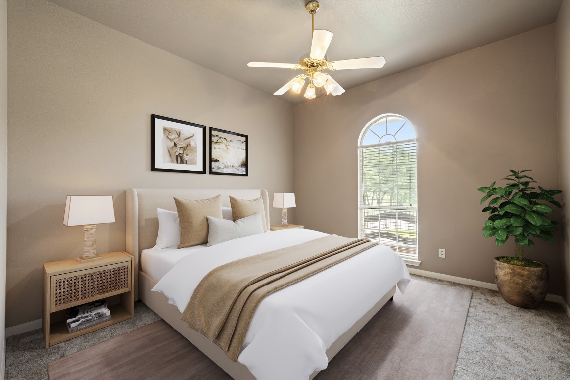 270 Rollin N Ranch Road Blanco, TX 78606 - Photo 10 of 27 a bedroom with a bed and a chandelier