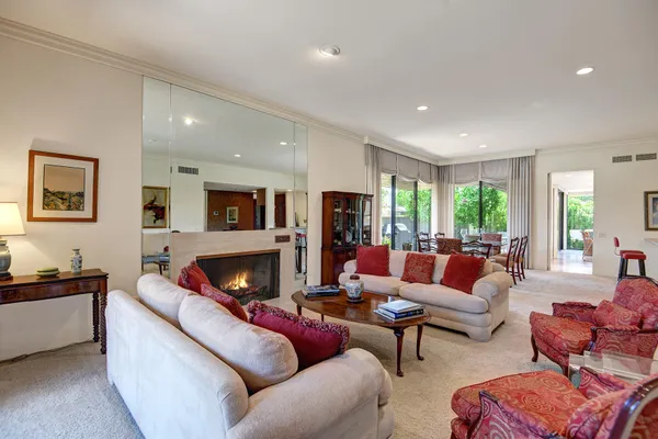 a living room with furniture fireplace and window